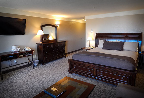 This spacious room is furnished with a king size bed, love seat and coffee table.